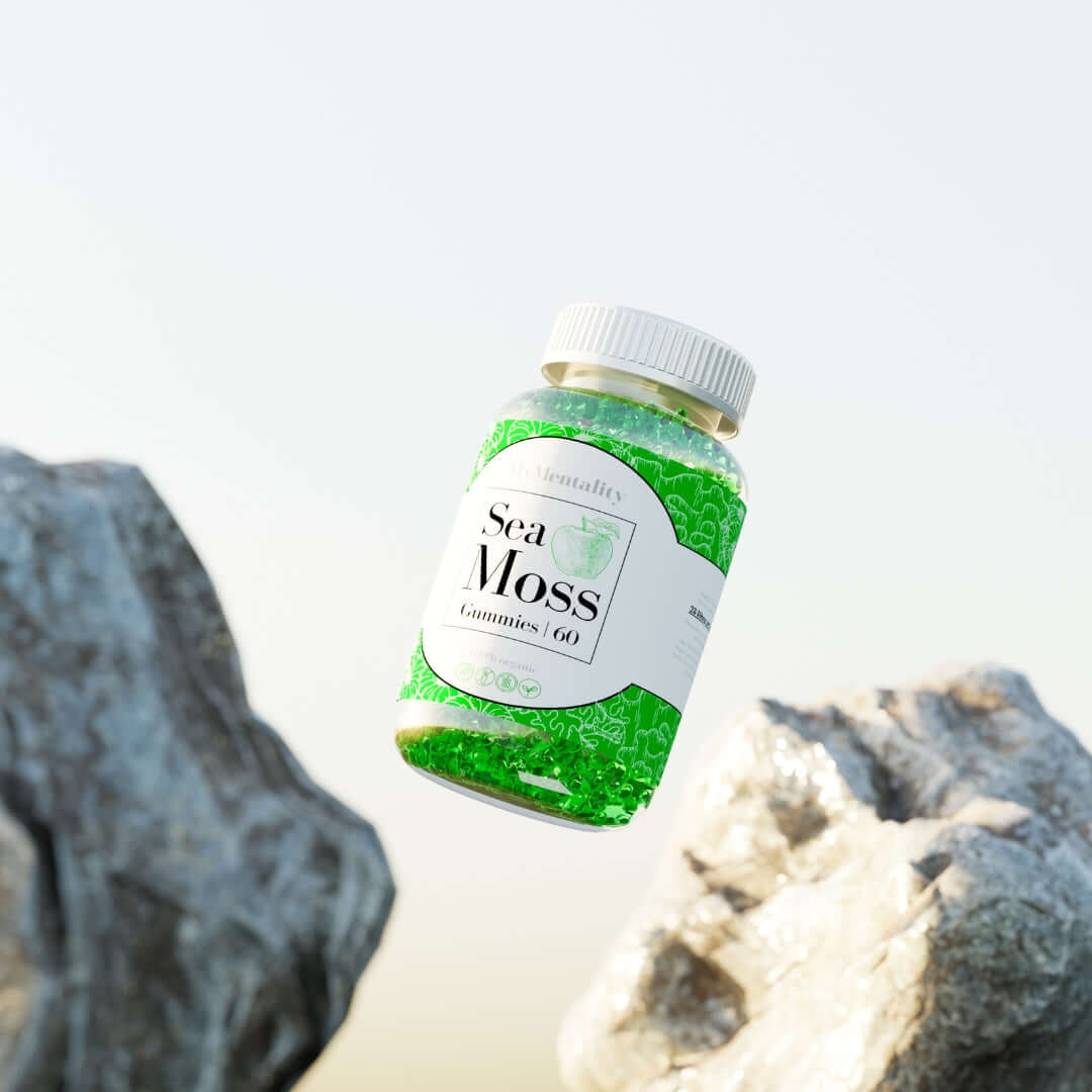 Sea Moss Gummies bottle floating above rocks, showcasing vibrant green apple-flavored gummies for wellness.